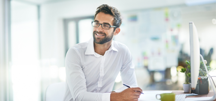 Image d’un homme souriant à son bureau